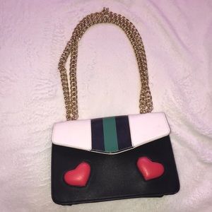 Black purse with red hearts and green line